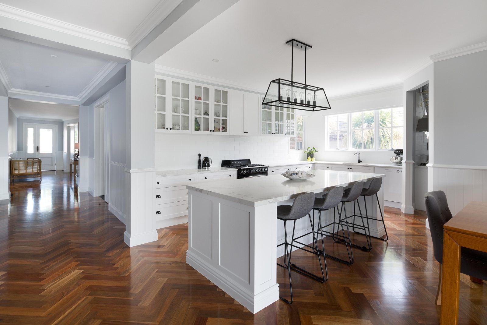 Kitchen with island bench, glazed overhead cabinets and herringbone floor, Civic Parade, Altona